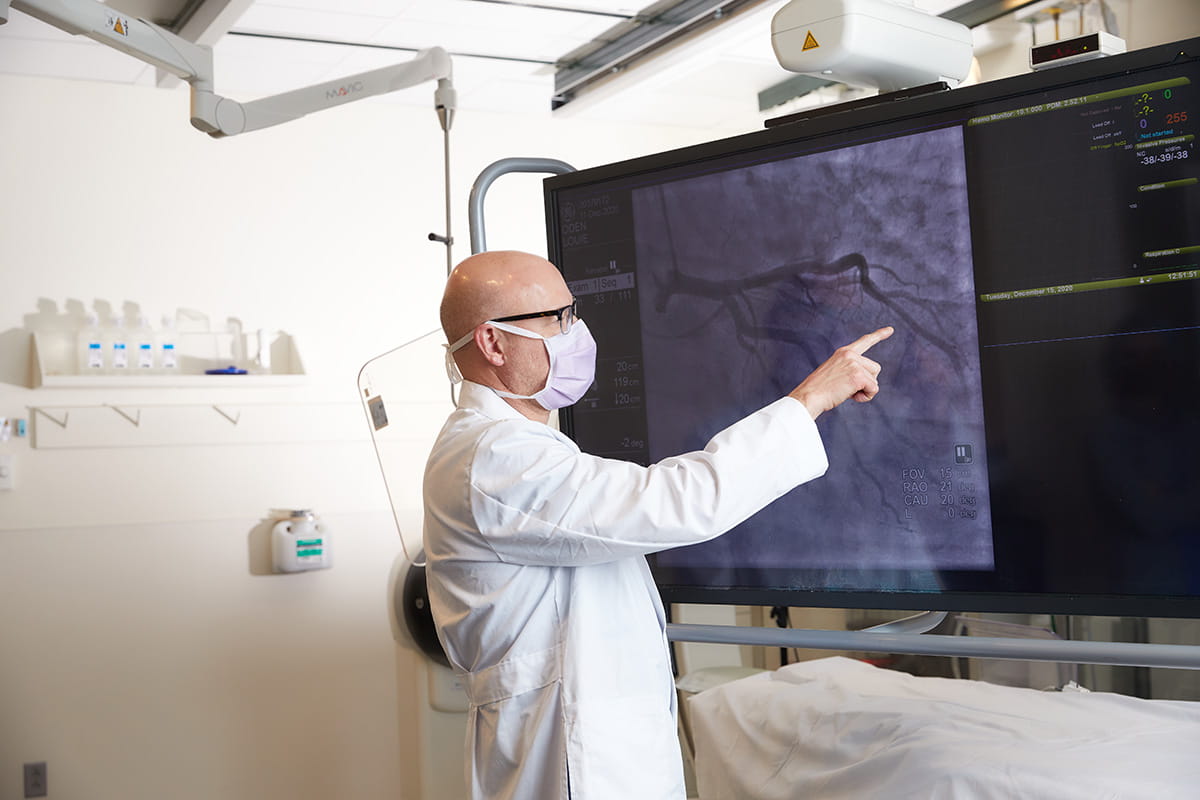 Dr. Mark Zenker of Ascension Saint Thomas Heart, looks at a computer screen of a vascular image. 